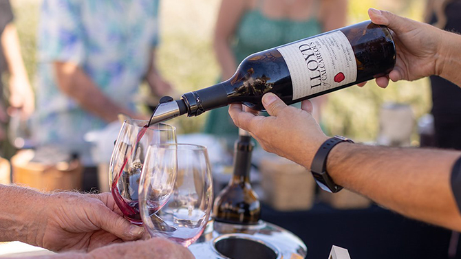 Guests wine tasting on the Calcareous lawn under a sunny Paso Robles afternoon